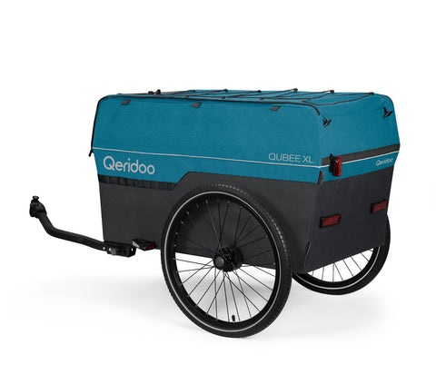 A Qeridoo Qubee XL cargo trailer attached to a bicycle, featuring a teal blue top canopy and a black lower body with black wheels, shown on a white background.